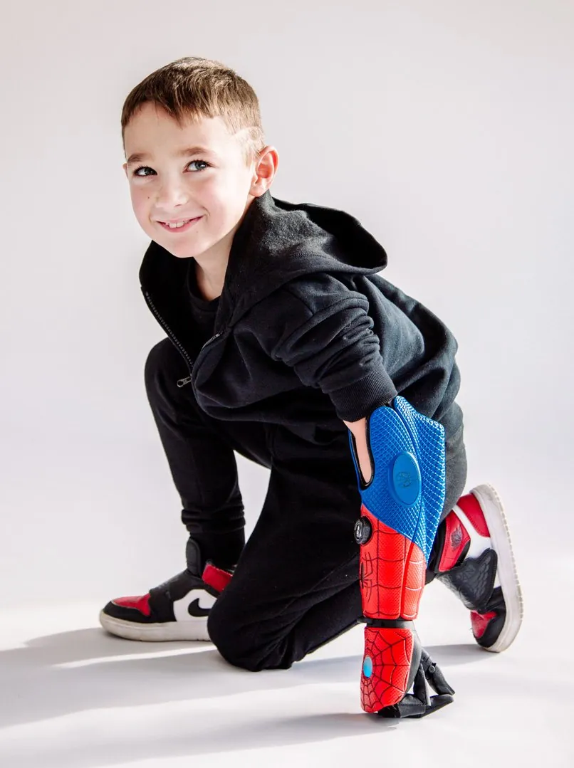 Boy kneeling in a Spider-Man Hero Arm and sneakers