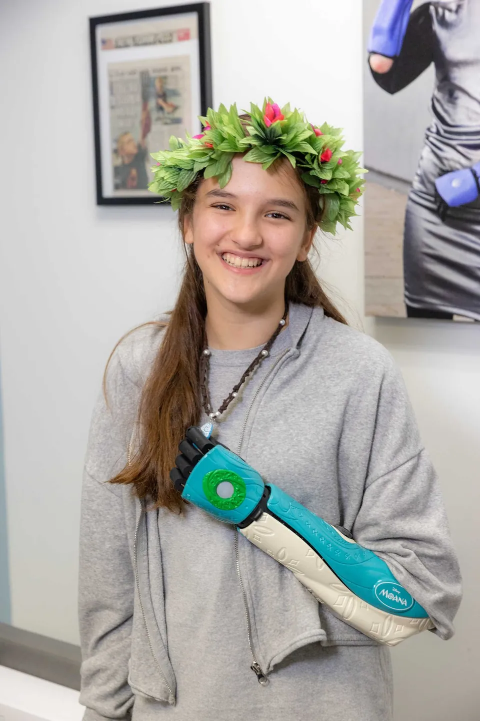 Carmela in a flower crown wearing her Moana Hero Arm
