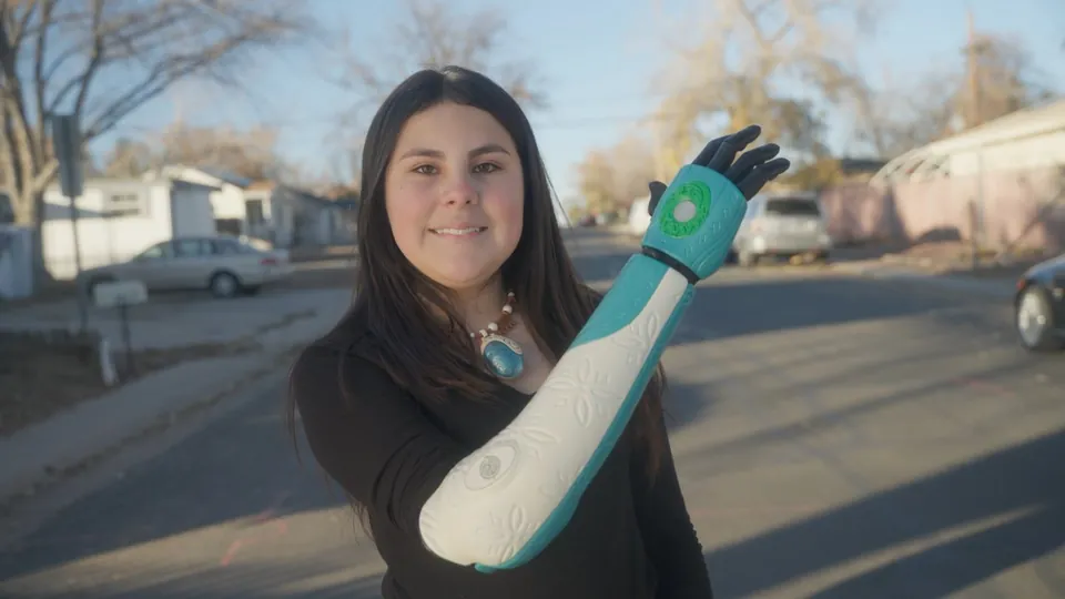 Dalilah outdoors, raising her Moana Hero Arm