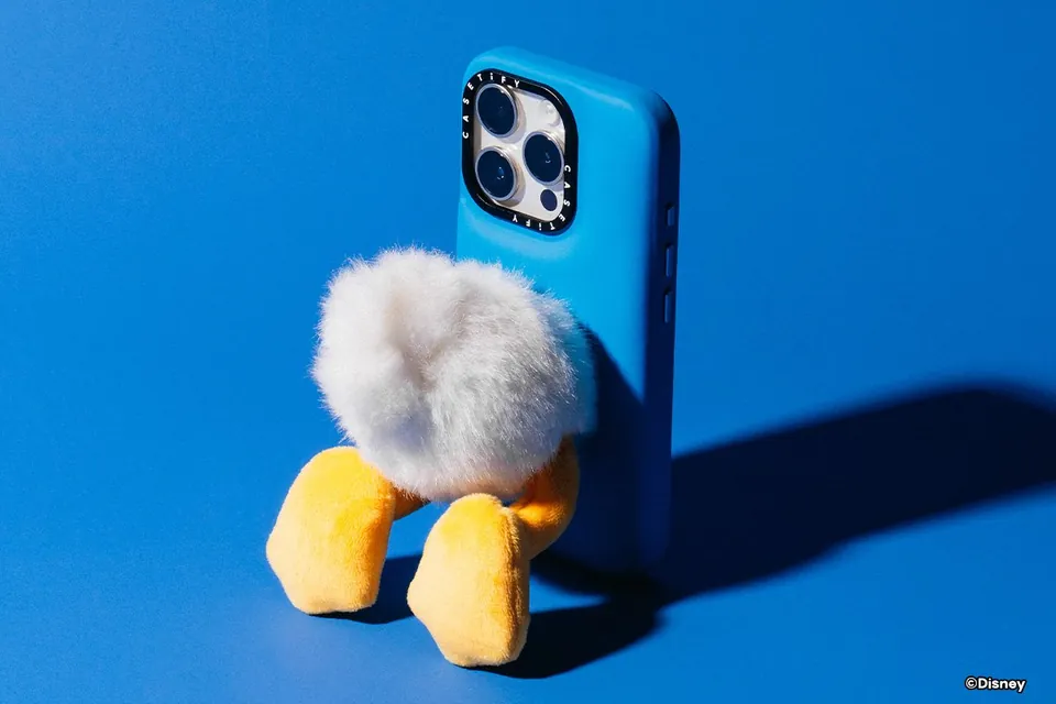 Donald Duck figural case with plush tail and dangling feet on blue