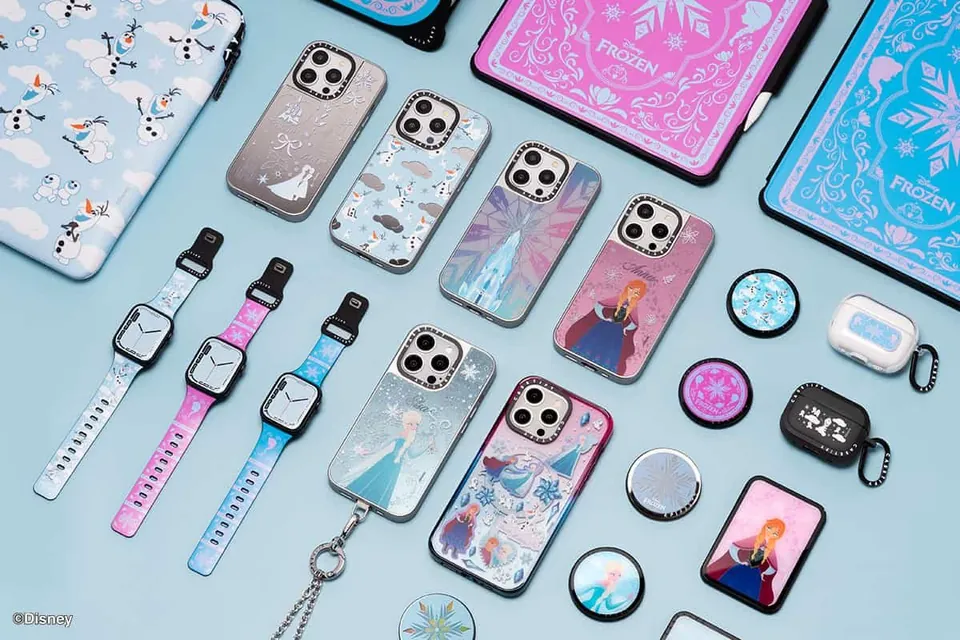 Full Frozen accessory collection — cases, bands, grips and earbud cases — flat lay on pale blue