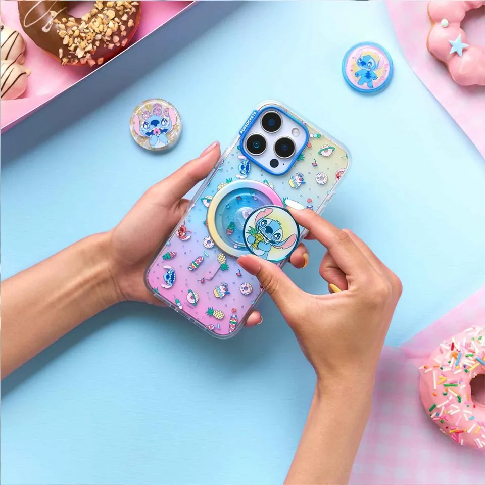 Jelly-style Stitch case and grip in hand over pastel donuts