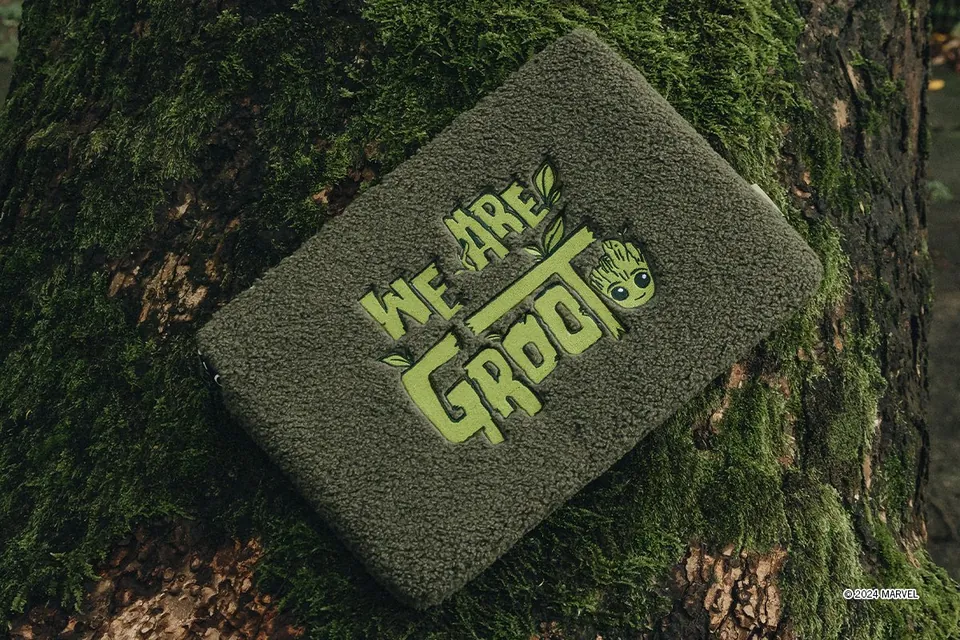 Textured green We Are Groot laptop sleeve on moss