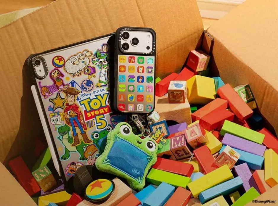 Toy Story 5 case in a cardboard box of wooden blocks with a Lilypad plush charm