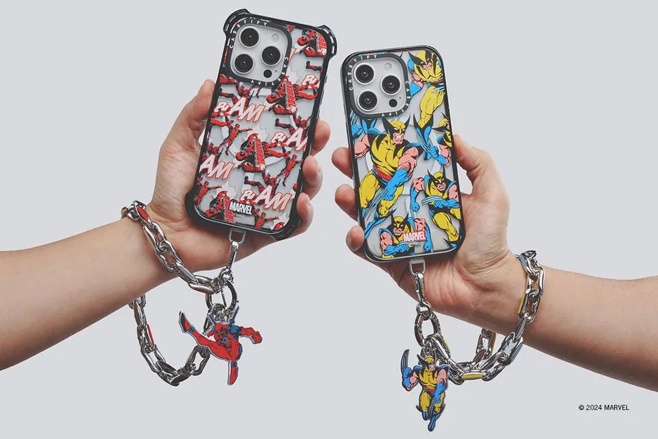 Two Deadpool and Wolverine cases in hand with character charms