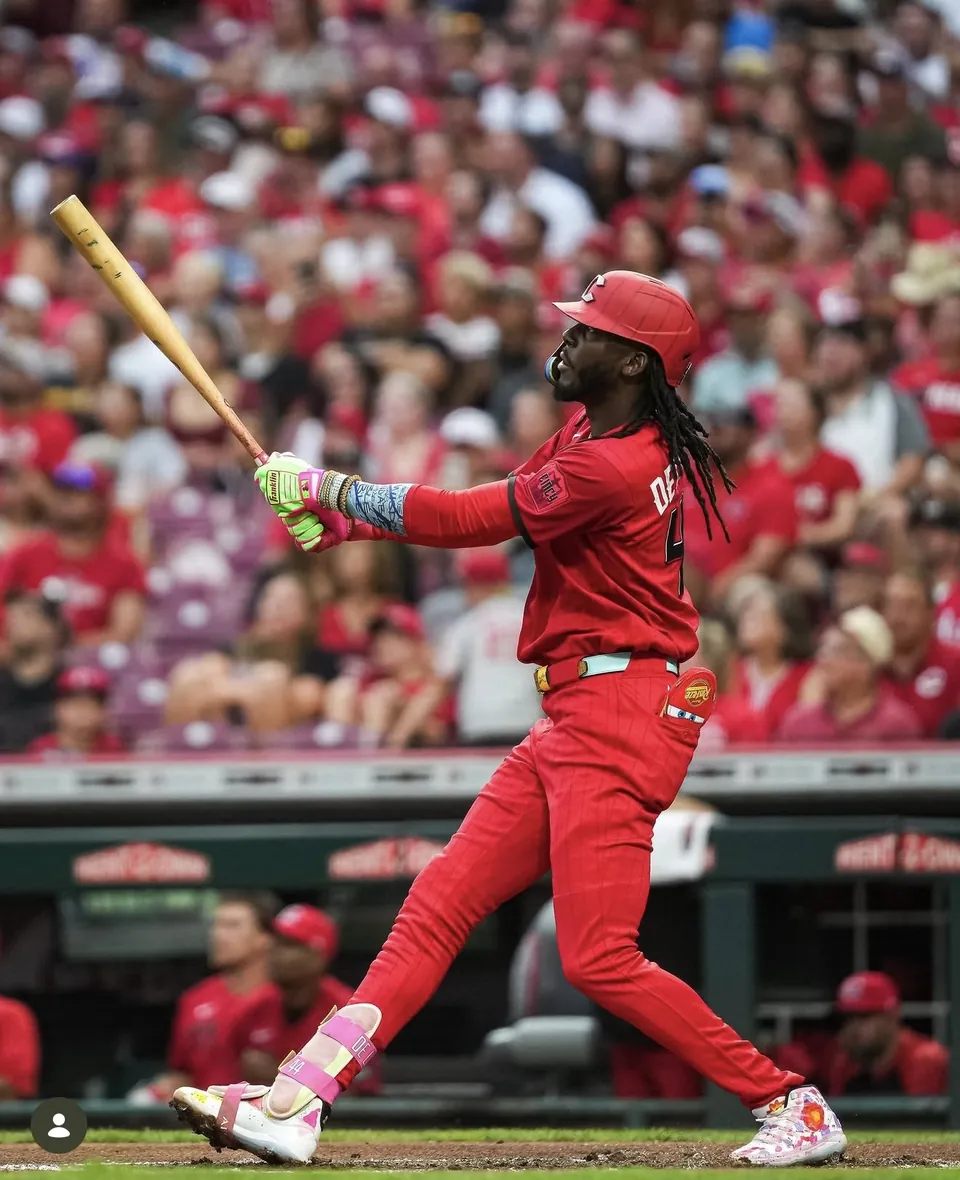 Cincinnati Reds hitter mid-swing wearing Lightning McQueen gear
