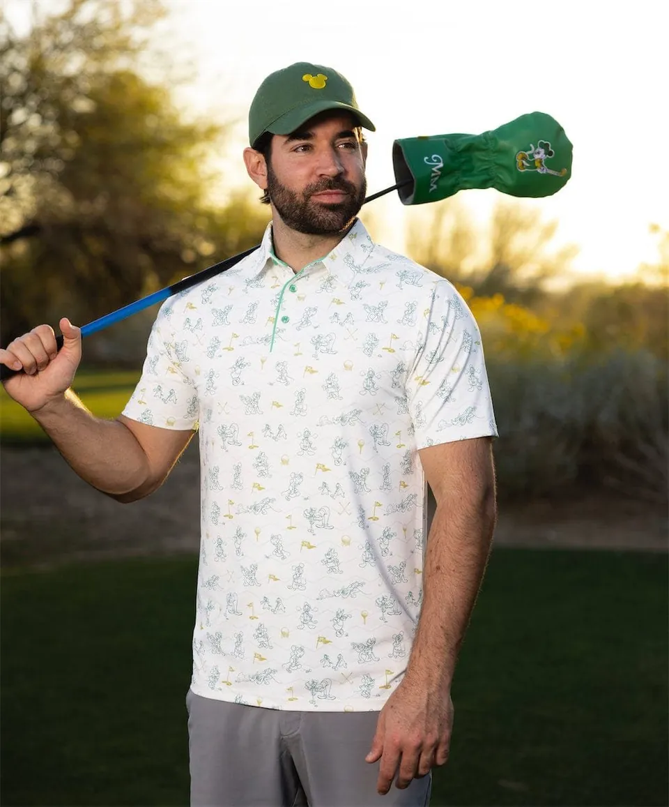 Golfer carrying a club with a Mickey Country Club headcover over his shoulder