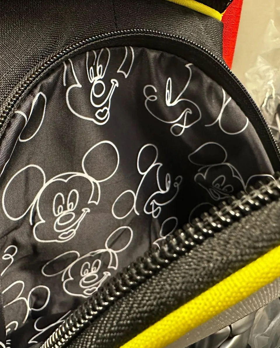 Mickey line-drawing pocket lining inside a black golf bag