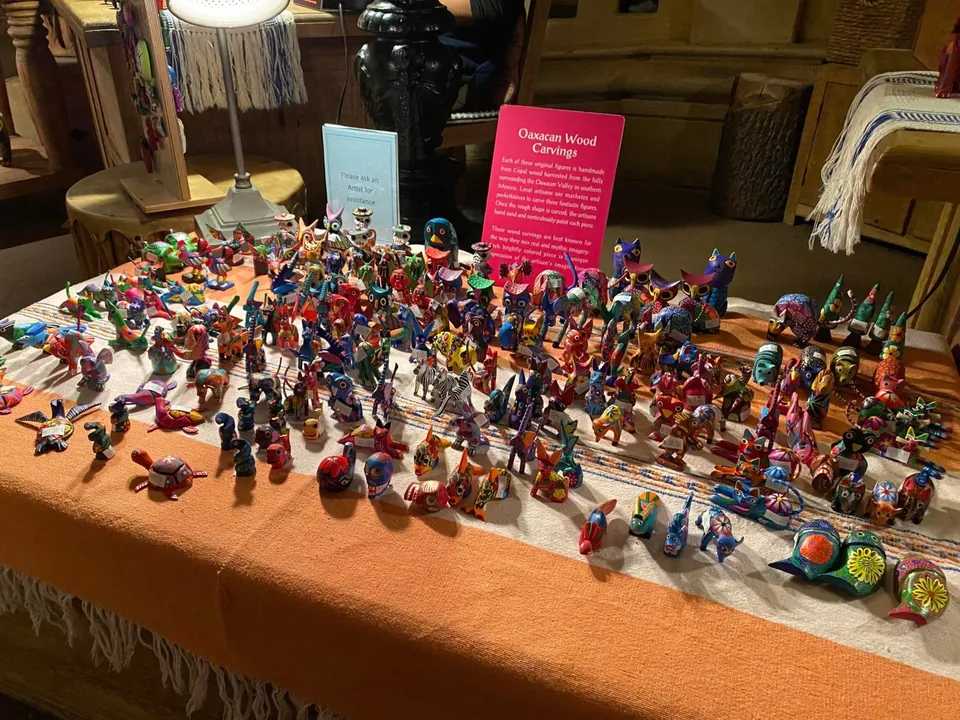 Alebrije carvings arranged across a table in the EPCOT Mexico pavilion shop