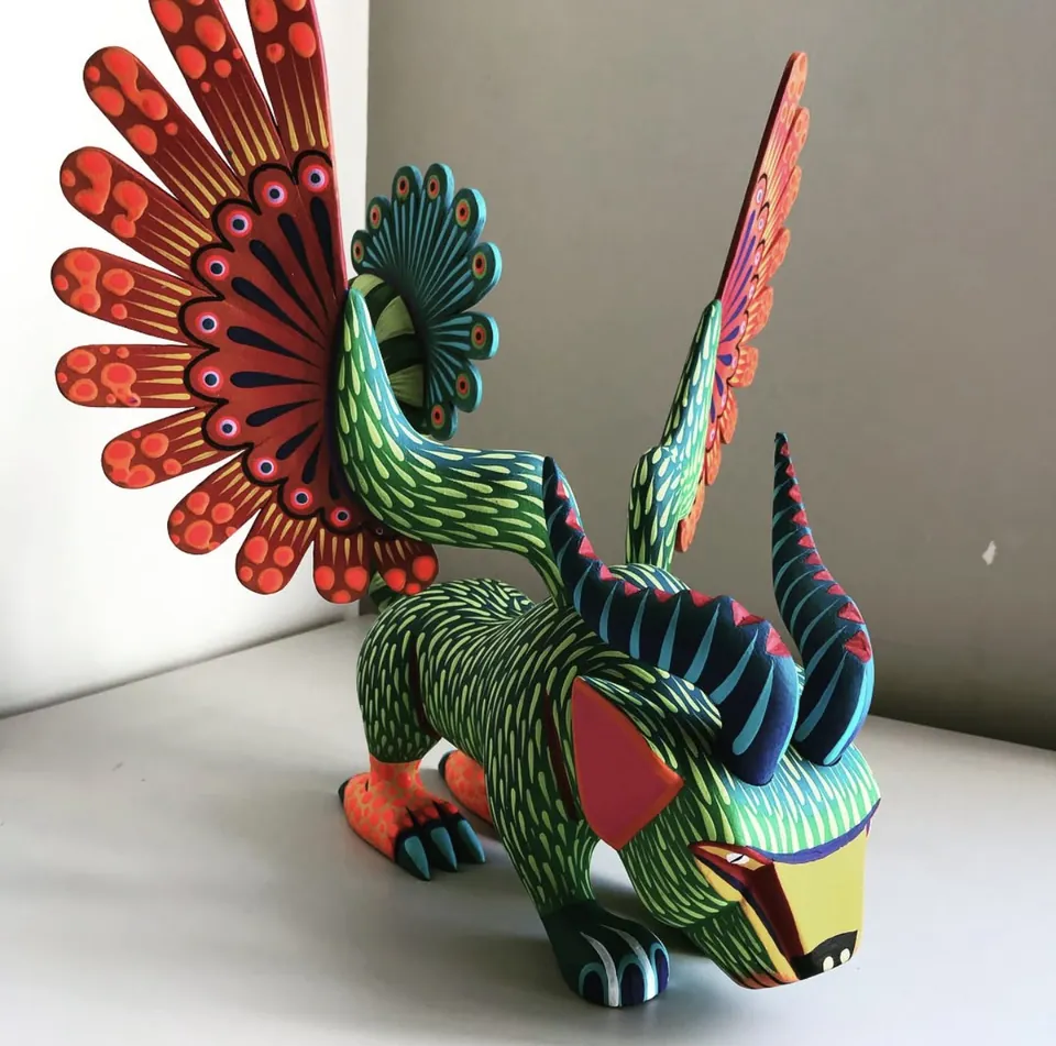 Hand-carved and painted Oaxacan alebrije of Pepita from Coco — winged, horned and covered in dot and dash patterning
